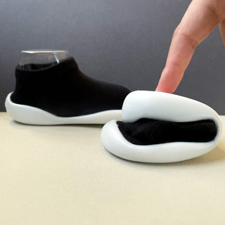 flexible black sock shoes with white rubber soles